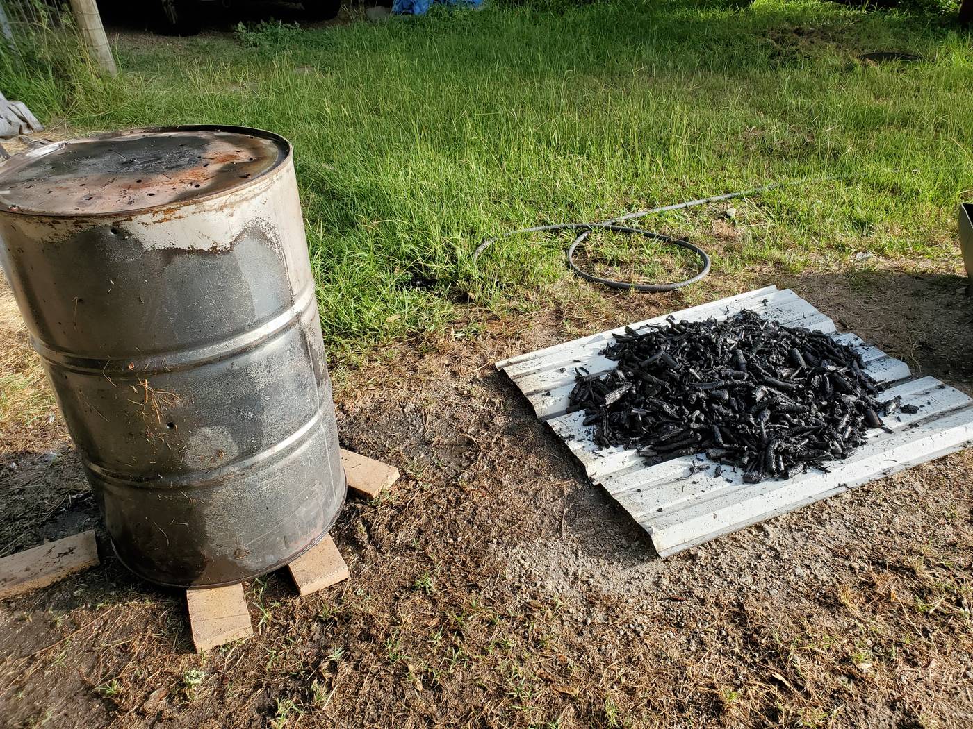 Finished biochar — dark crumbly porous carbon ready to amend the soil