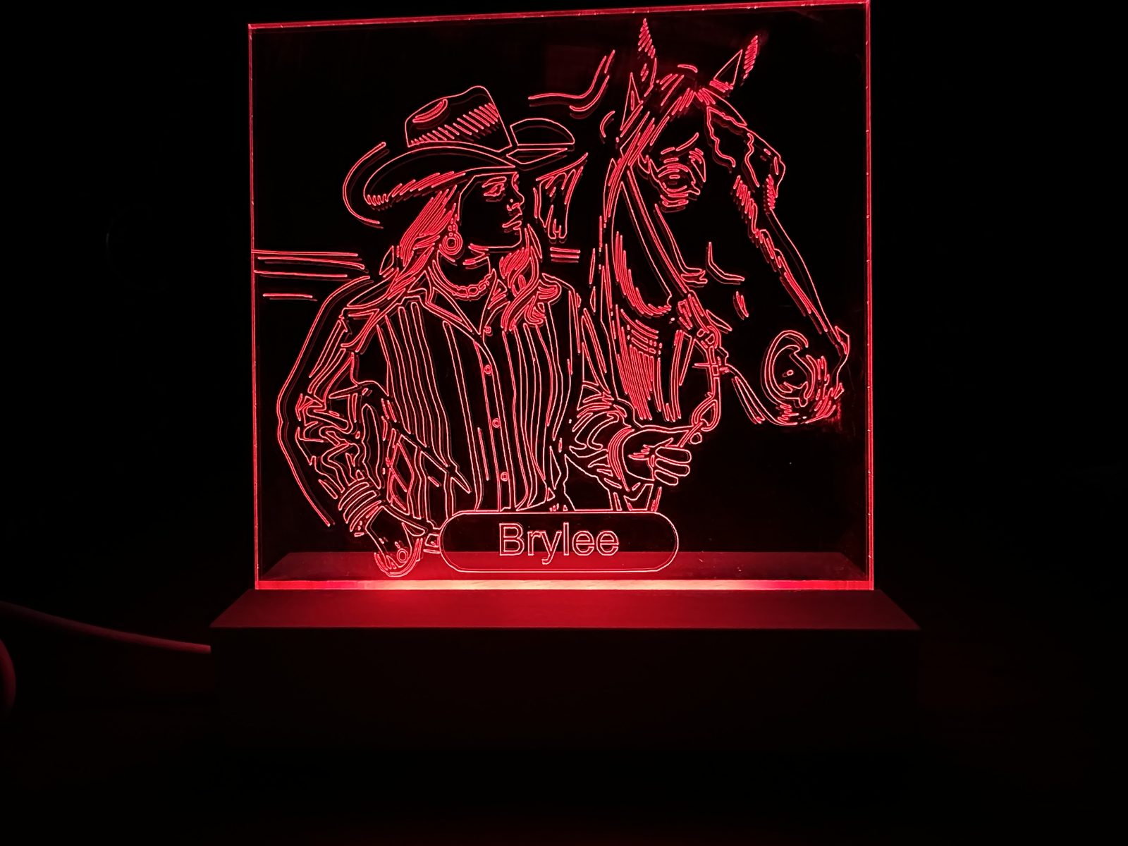 Laser-engraved acrylic with red LED edge lighting showing personalized name Brylee